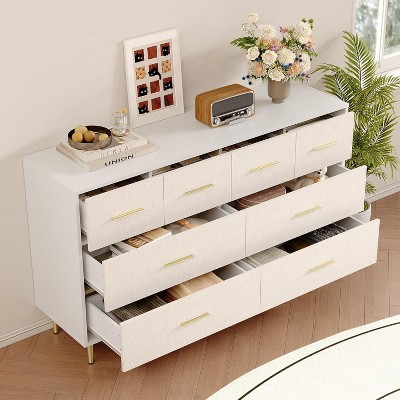 White dresser with drawers open showing storage