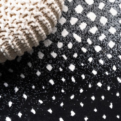 Abstract Antelope 8' x 10' Black and Ivory Synthetic Area Rug