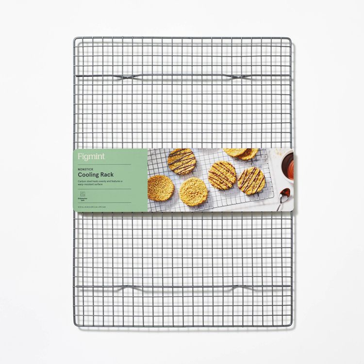 A metal cooling rack with a green label showing cookies and the text "Figmint Nonstick Cooling Rack."