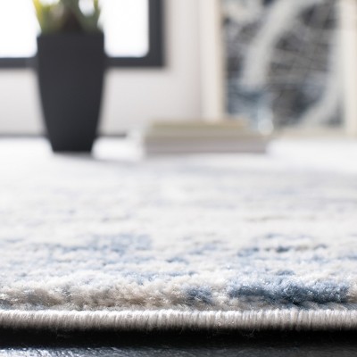 Ivory and Blue Abstract Round Synthetic Area Rug