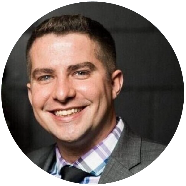 Clayton Brady, Target Lead iOS Engineer smiling against a dark background wearing a gray suit jacket, patterned button down shirt and tie