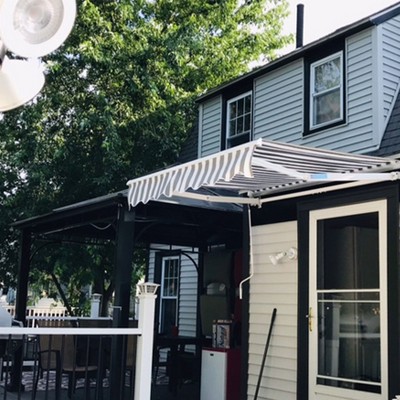 Grey and White Striped Retractable Patio Awning with White Frame