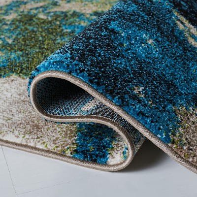 Navy and Green Abstract 4' x 6' Synthetic Area Rug