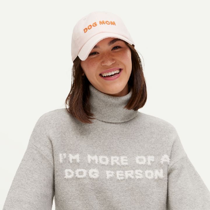 woman with dog mom cap and graphic sweater from the collection.