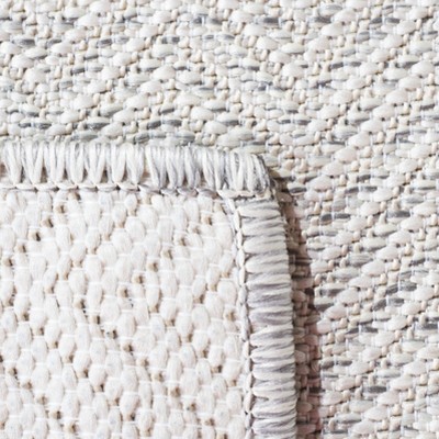 Ivory and Multi 5'1" x 7'6" Synthetic Indoor/Outdoor Area Rug