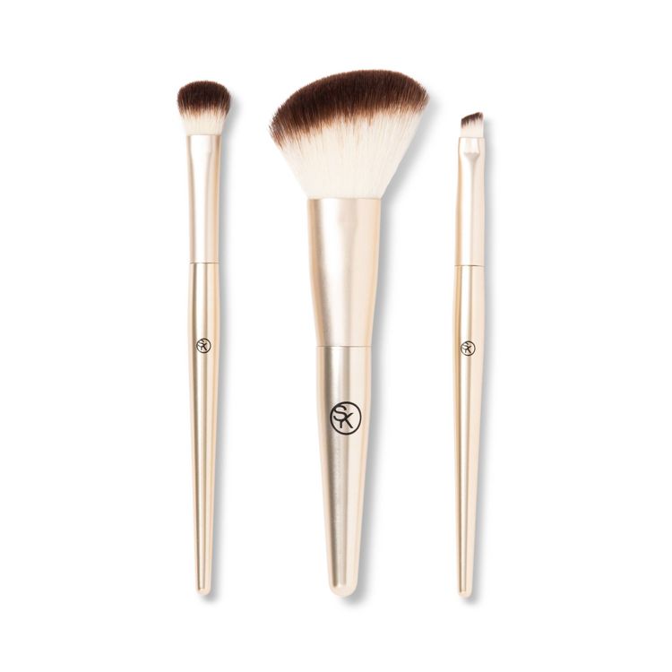 Three makeup brushes with gold colored handles and brown-tipped bristles, each featuring a different brush head shape, displayed on a white background.