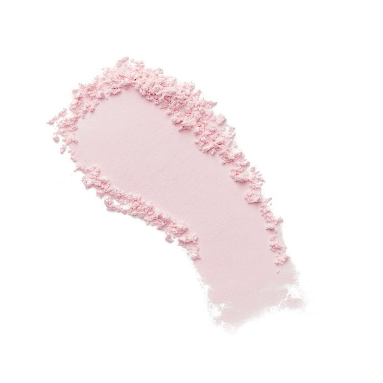 A swatch of light pink loose setting powder on a white background. The powder is clumped on the edges and smooth in the center, showing its fine texture.