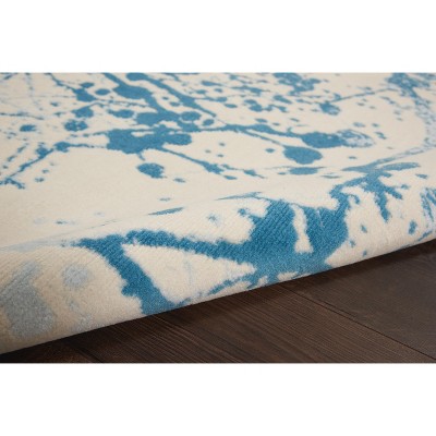 Ivory and Blue Abstract Synthetic 4' x 6' Easy-Care Area Rug