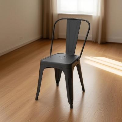 Dyonery 4 black metal chairs, with multi-hole seat designs and backrest arcs that conform to the curves of the human back