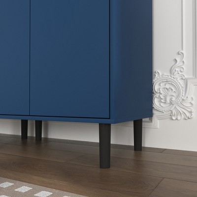 Blue cabinet base and legs near decorative wall