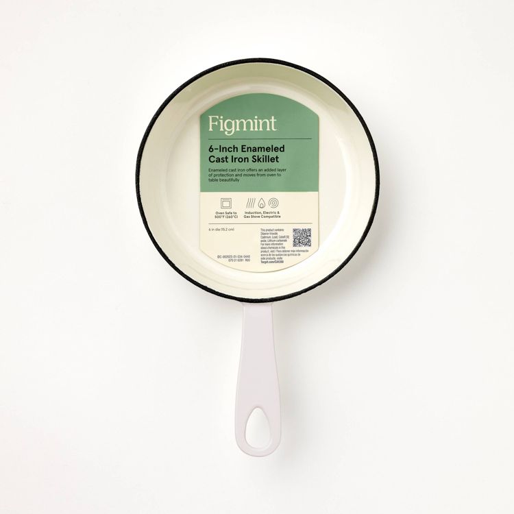 A white colored 6-inch enameled cast iron skillet with a light pink handle and a label inside.