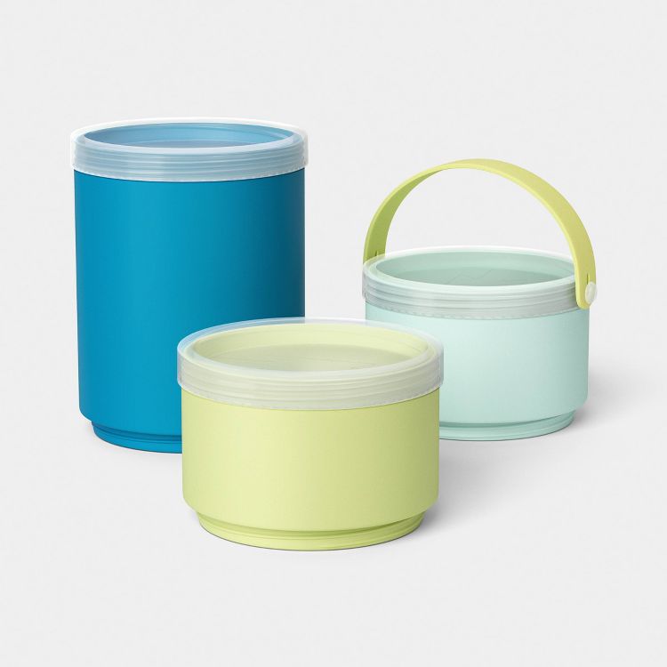 Three cylindrical containers in blue, light green, and mint green colors, with clear lids, and one container featuring a yellow handle.
