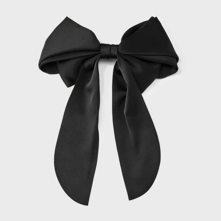 A large black colored bow-shaped barrette with long tails.