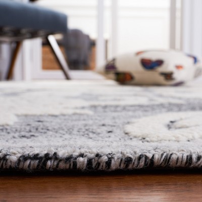 Handmade Black and Ivory Floral Wool Area Rug, 5' x 8'