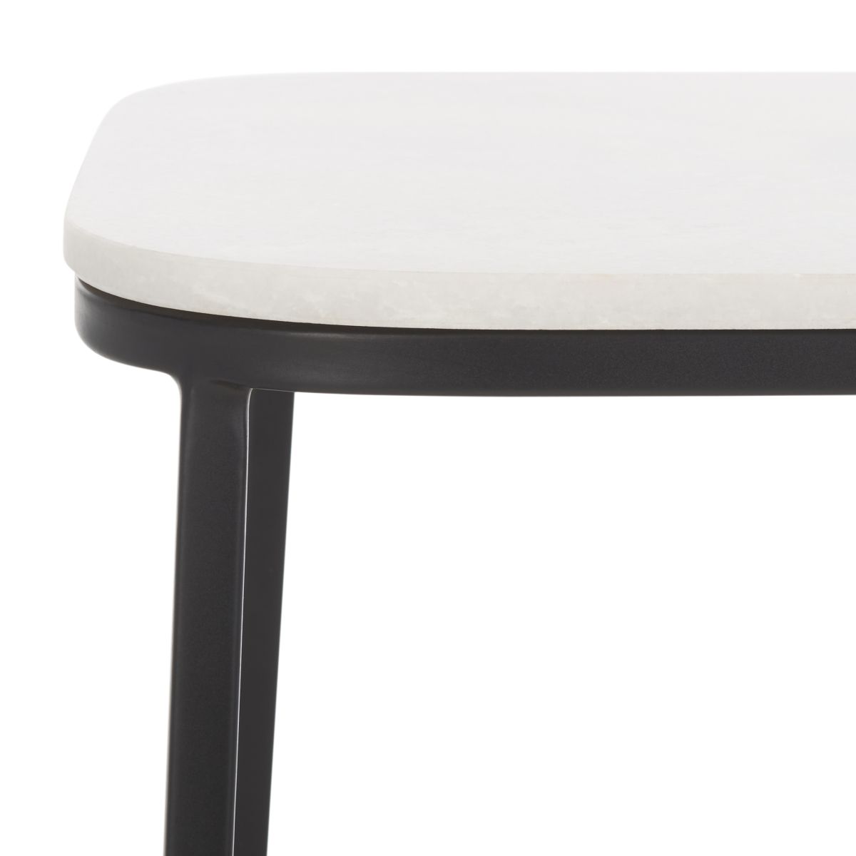 Close-up of white marble-look tabletop and black side table leg