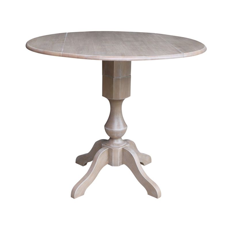 Kayden Round Dual Drop Leaf Pedestal Table Washed Gray Taupe - International Concepts, 1 of 10