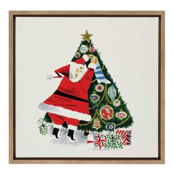 22" x 22" Sylvie Santa Claus Decorating Tree Framed Wall Canvas by Corinna Buchholz Gold - Kate & Laurel All Things Decor