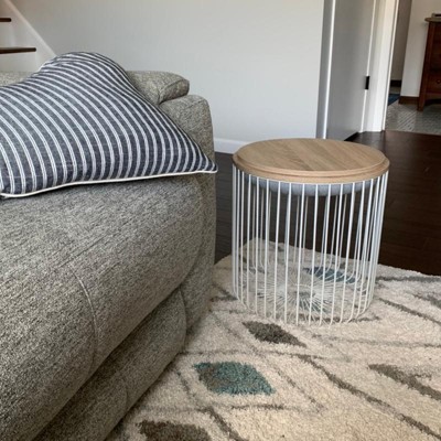 A cushion-top wire storage ottoman/stool so you can prop up your feet on  something that looks like it belongs in the Museum of Modern Art. The top  flips over to…