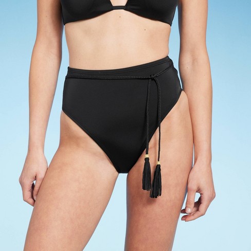 Woman in black bikini bottom and black brassiere on beach during