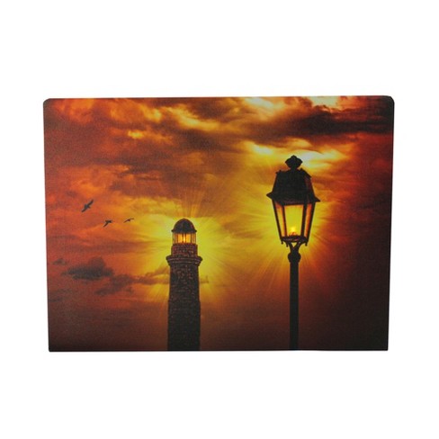 Northlight LED Lighted Lighthouse and Lantern Lamp Post with Amber Sky Canvas Wall Art 15.75 x 11.75