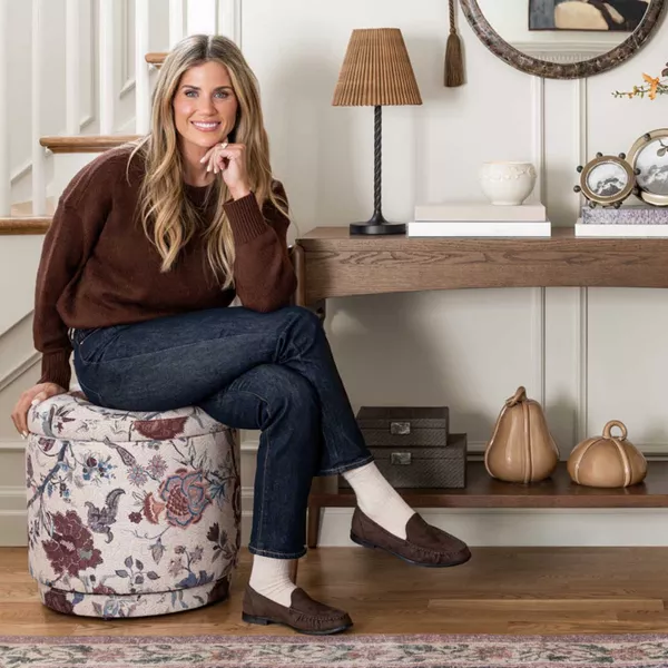 Shea McGee sitting in fall styled entry