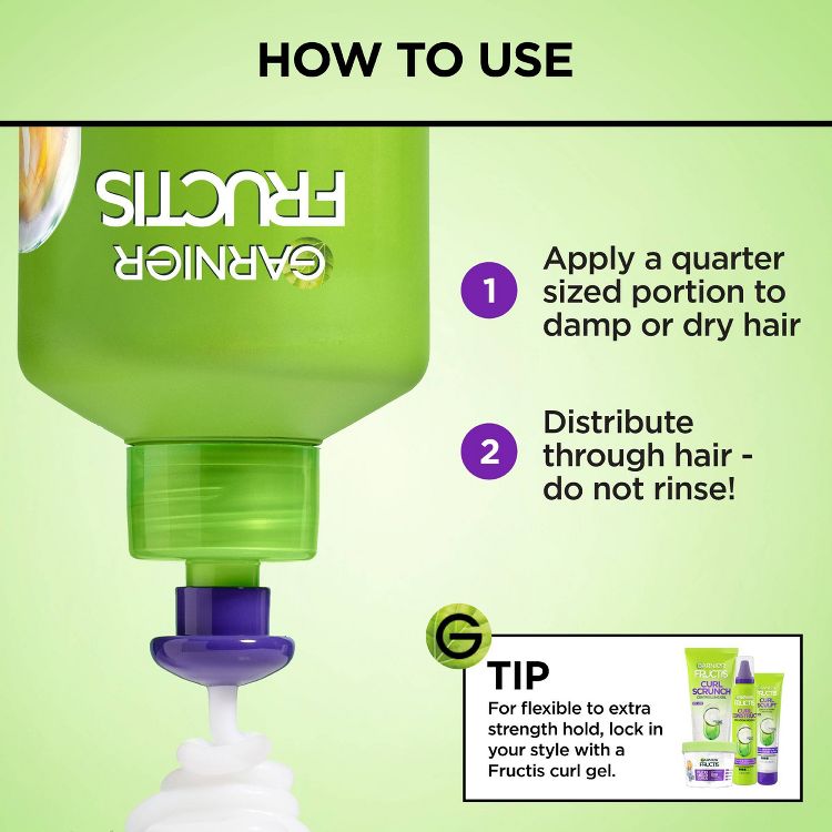 Green colored bottle of Garnier Fructis with instructions to apply a quarter-sized portion to damp or dry hair, distribute through hair without rinsing, and a tip to use Fructis curl gel for extra hold.