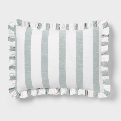 A rectangular pillow with light blue and white colored vertical stripes and ruffled edges.