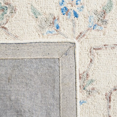 Elegant Ivory Wool 9' x 12' Hand-Tufted Rectangular Rug