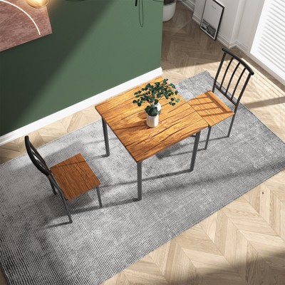 Wood dining table with two chairs and bench in a living room