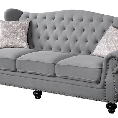 Gray Fabric Camelback Sofa with Floral Cushions and Nailhead Trim