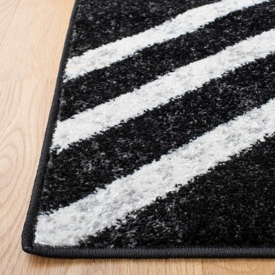 Black and Ivory Geometric 4' x 6' Synthetic Area Rug