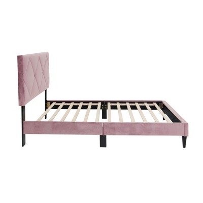 Left side angle view of pink upholstered bed showing frame and slats