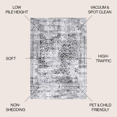 Ivory and Black Geometric Synthetic 8' x 10' Area Rug
