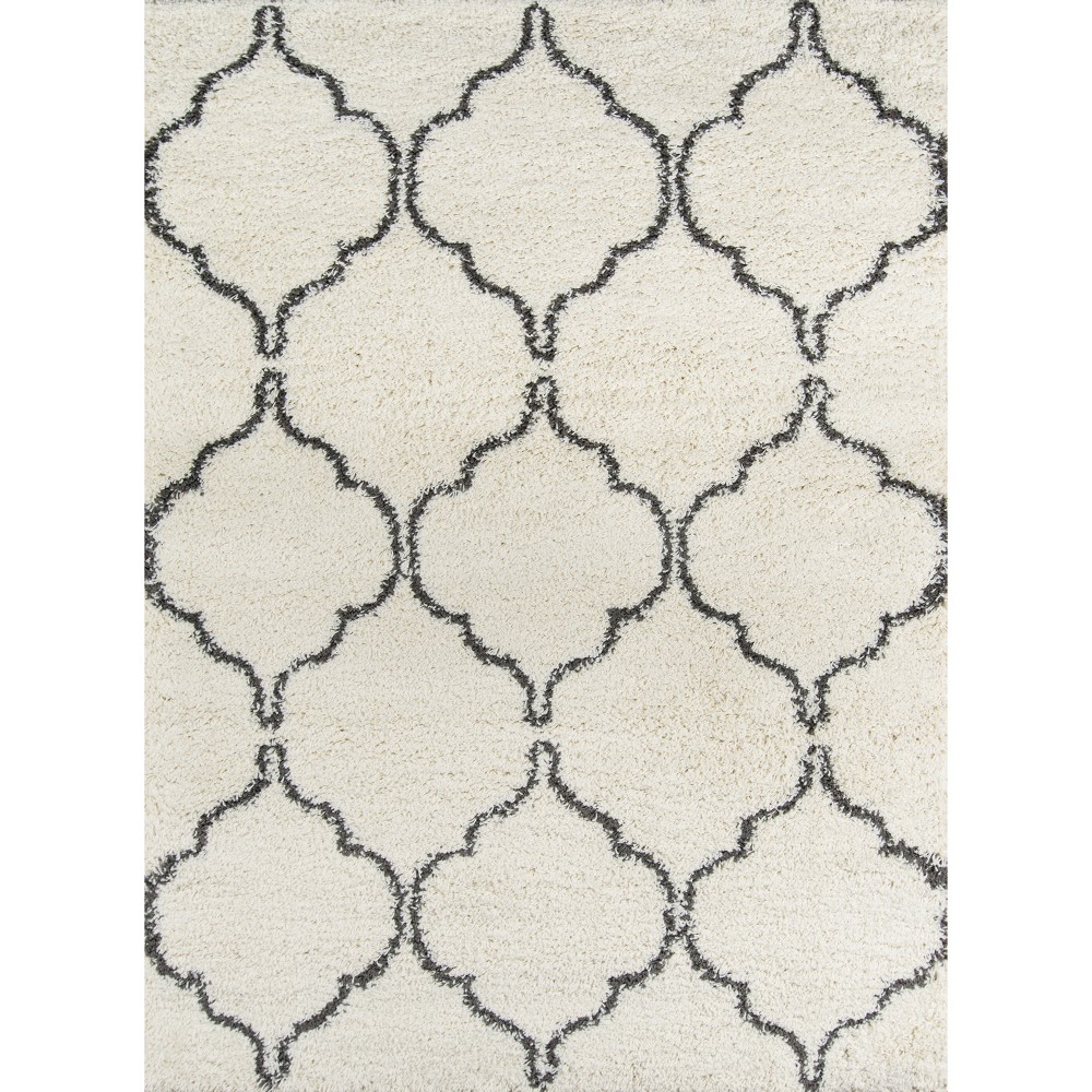 Momeni Maya Ivory 9'3  X 12'6  Area Rug The graphic patterns of this shaggy area rug create a stylish combination of town and country. Versatile enough for classic and contemporary floors, the versatile floorcovering assortment boasts an array of repeating arabesques and diamond designs and textures inspired by Moroccan Berber carpets. Power loomed from sumptuous polypropylene fibers, the dense pile of each decorative floorcovering invites you to sit on the floor and stretch out. Size: 9'3 x12'6 . Color: Ivory. Pattern: Geometric.