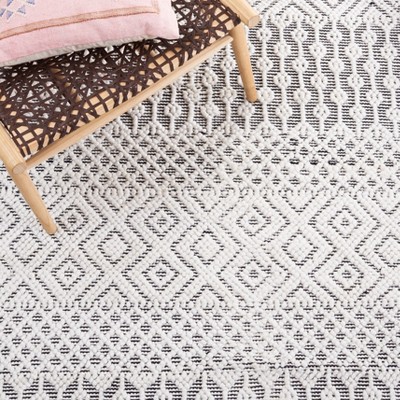 Handmade Black and Ivory Round Tufted Shag Rug