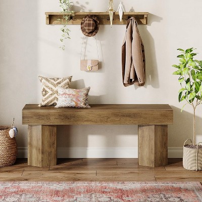 Bench in a cozy entryway with coat rack and plants