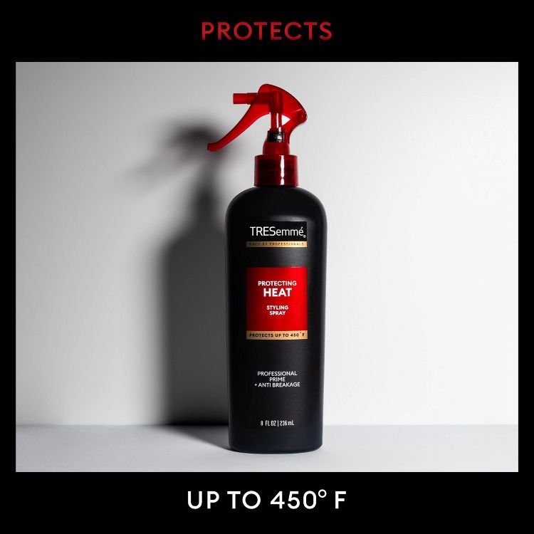 Black bottle of TRESemmé Protecting Heat Styling Spray with a red trigger, labeled to protect up to 450°F, 8 fl oz (236 ml).