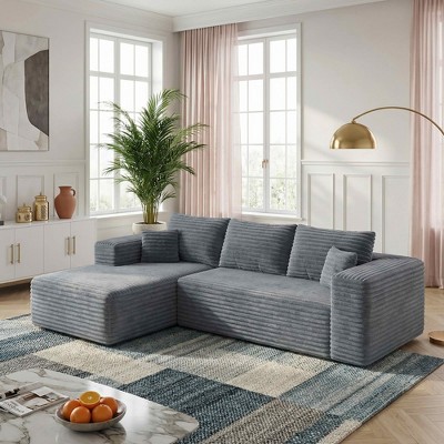 Large gray corduroy sectional sofa in a bright room