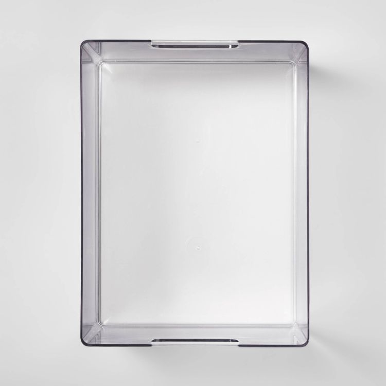 A clear rectangular bathroom tray with slightly raised edges and a transparent design.