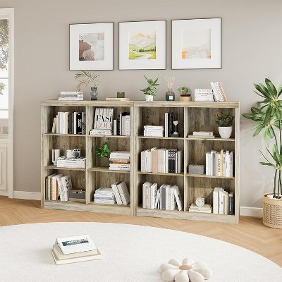 Two identical bookcases arranged in a room with wall art