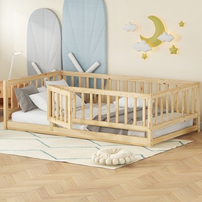 Angle view of twin size floor bed with fence and door section