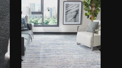 Ivory and Blue Abstract 6&#039; x 9&#039; Stain-Resistant Synthetic Rug