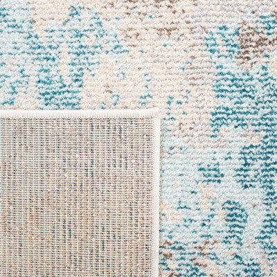 Ivory and Teal 4' x 6' Synthetic Non-Slip Rectangular Rug