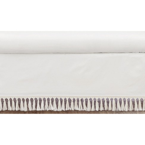 White crib skirt with 2024 tassels