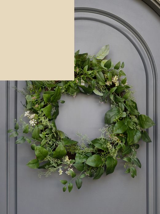Faux greenery wreath on blue front door.