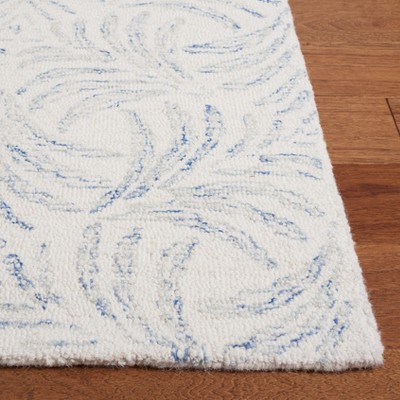 Ivory and Blue Floral Tufted Wool 4' x 6' Area Rug