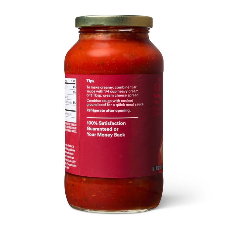 A glass jar filled with red colored sauce featuring a label with cooking tips and a satisfaction guarantee message.