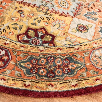 Handmade Round Red and Rust Wool Area Rug
