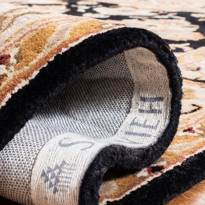 Hand-Tufted Black and Ivory Wool Oval Area Rug