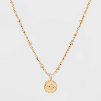 short gold necklace with charm